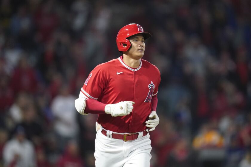 Los Angeles Angels' Shohei Ohtani (17) runs the bases after hitting a home run during the fifth inning of a spring training baseball game against the Los Angeles Dodgers in Anaheim, Calif., Sunday, April 3, 2022. (AP Photo/Ashley Landis)