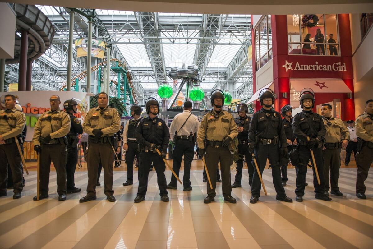 Police line up to move Black Lives Matter protestors out of the rotunda area of the Mall of America.