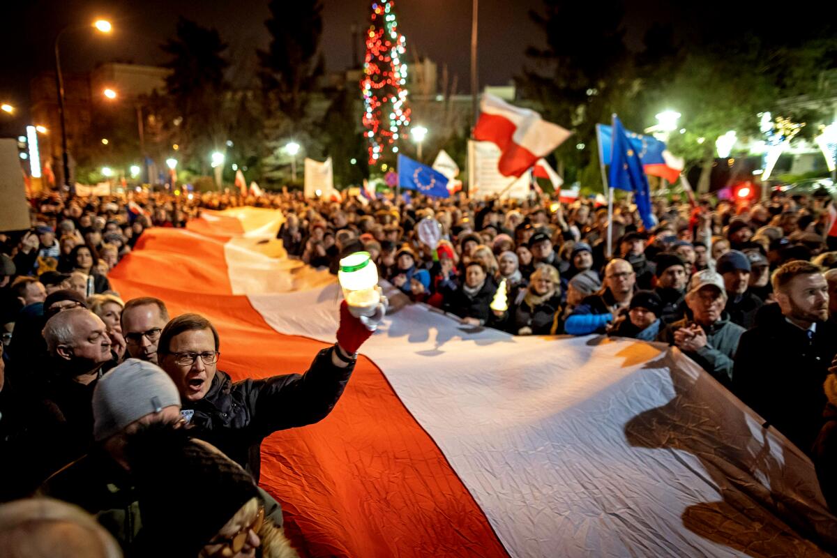 Polish protesters with a giant national flag