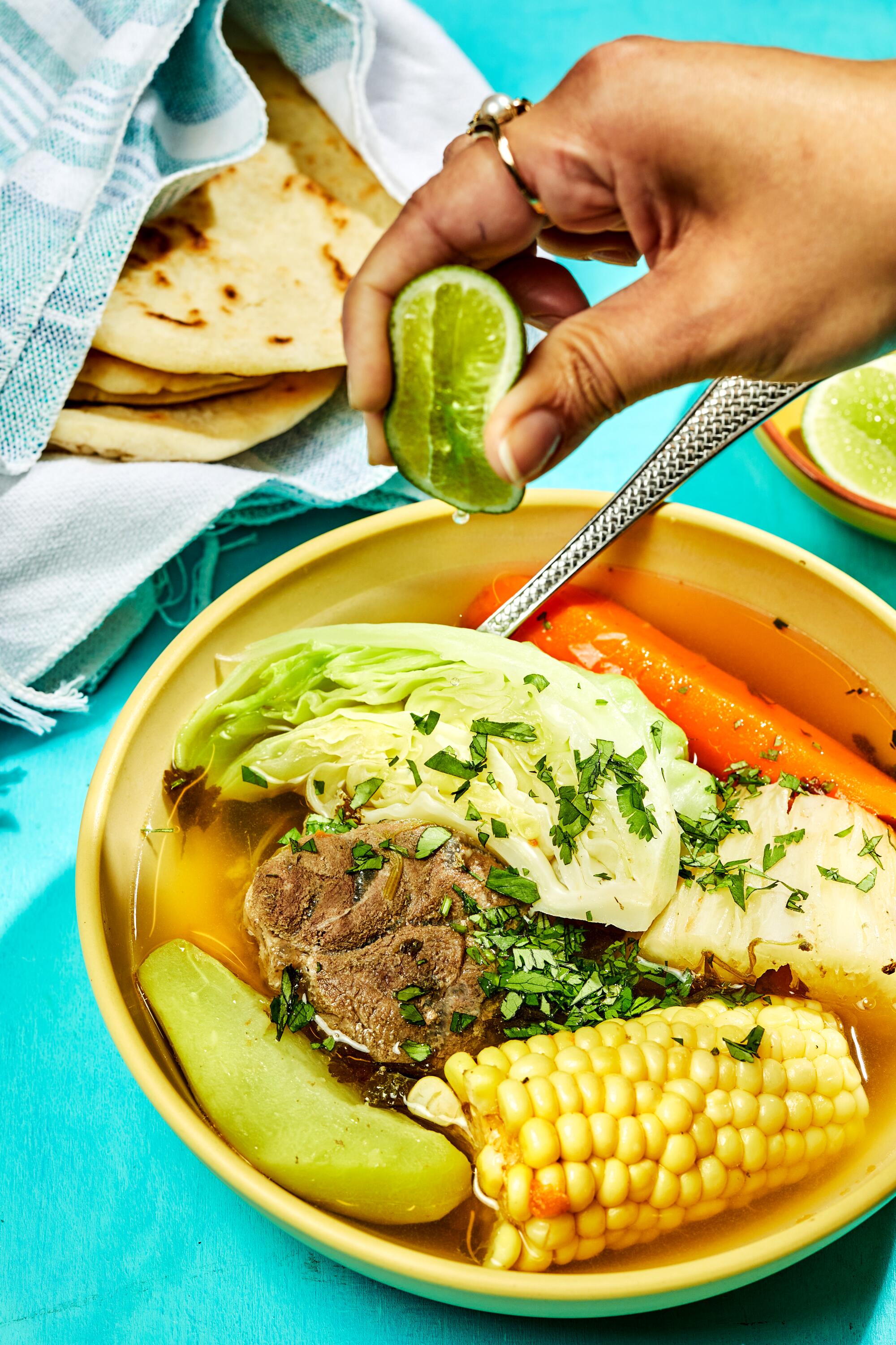 A comforting bowl of beef soup made with beef shank, chayote, yucca, corn and cabbage.