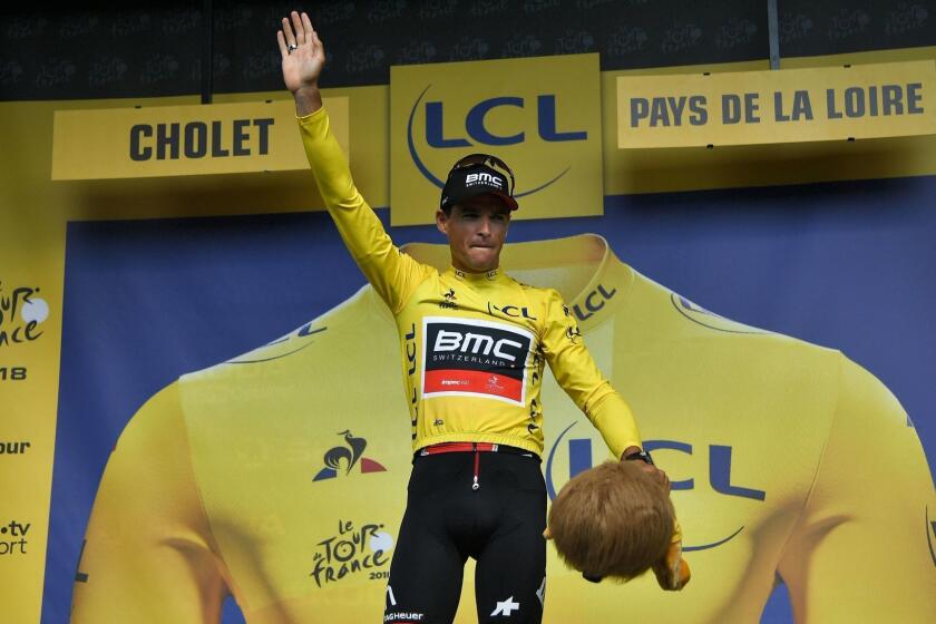Belgium's Greg Van Avermaet, wearing the overall leader's yellow jersey, waves from the podium after USA's BMC Racing cycling team won the third stage of the 105th edition of the Tour de France cycling race, a 35.5 km team time-trial around Cholet, western France, on July 9, 2018. / AFP PHOTO / Marco BERTORELLOMARCO BERTORELLO/AFP/Getty Images ** OUTS - ELSENT, FPG, CM - OUTS * NM, PH, VA if sourced by CT, LA or MoD **