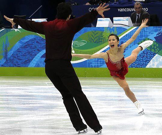 China's Shen Xue lands a jump as she and partner Zhao Hongbo turn in a gold-medal-winning performance in pairs figure skating Monday in the Winter Olympics at Vancouver, Canada.