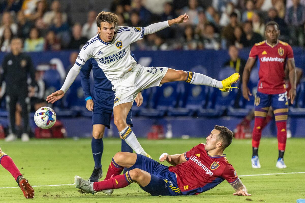 Galaxy midfielder Riqui Puig tries to avoid a slide tackle during a draw against Real Salt Lake on Oct. 1.