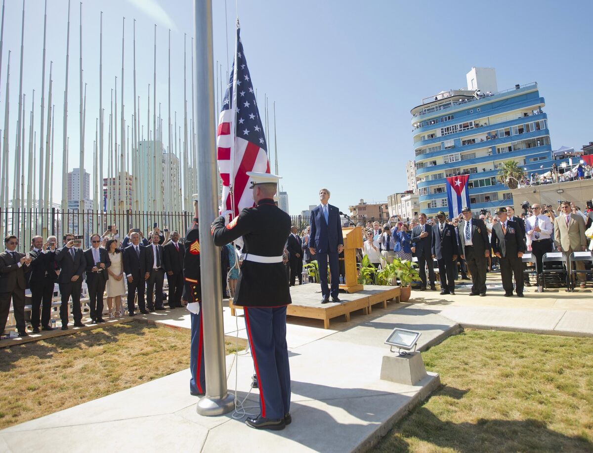 Secretary of State John F. Kerry and other dignitaries watch Friday as U.S. Marines raise the American flag over the newly reopened embassy in Havana.