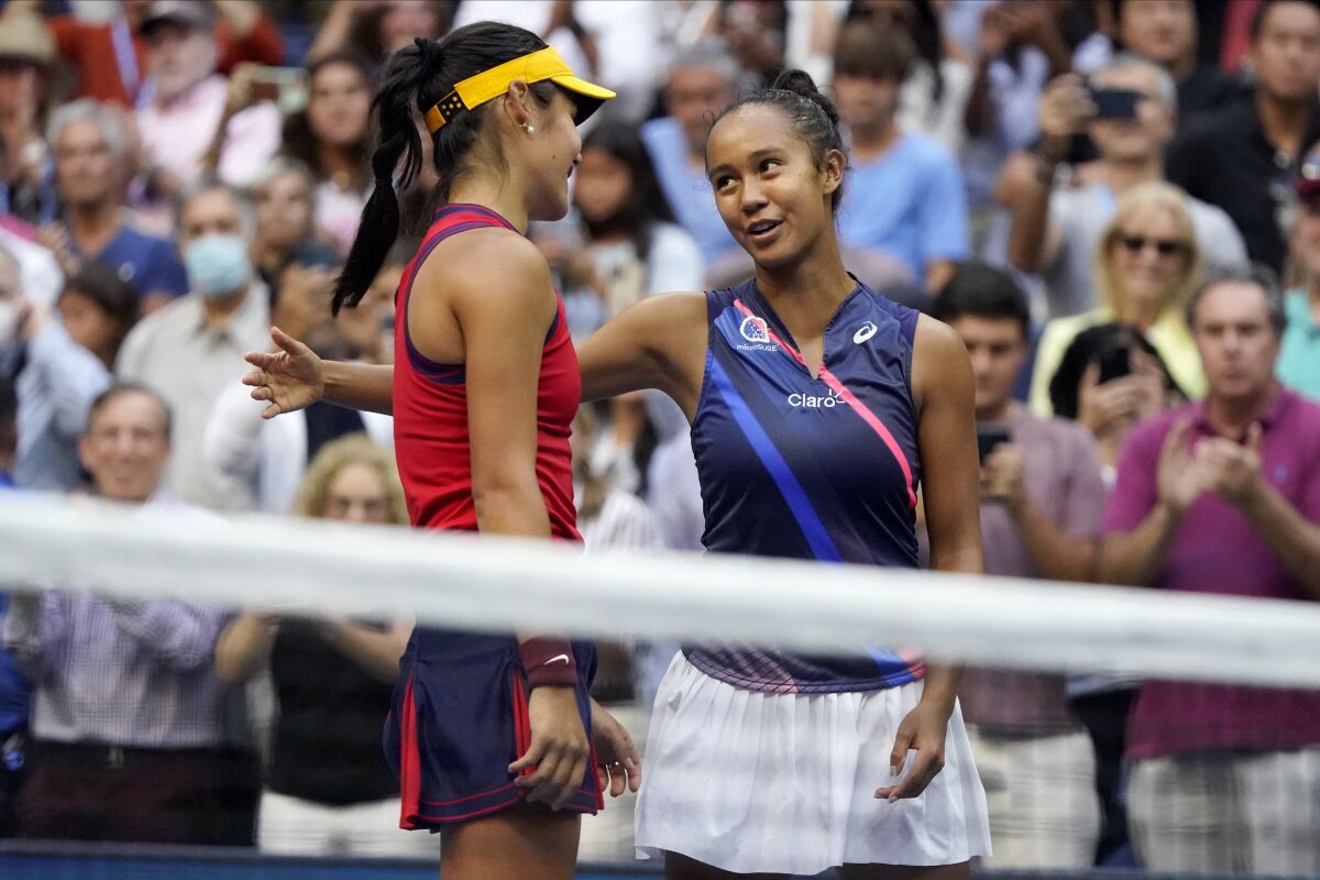 Emma Raducanu, left, and Leylah Fernandez talk after Raducanu's win at the U.S. Open on Saturday.