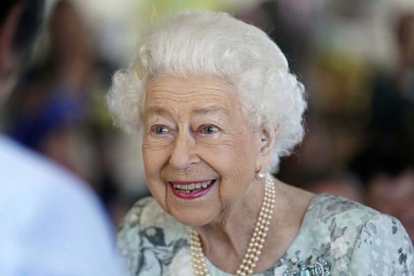 FILE - Britain's Queen Elizabeth II looks on during a visit to officially open the new building at Thames Hospice, Maidenhead, England July 15, 2022. Buckingham Palace says Queen Elizabeth II is under medical supervision as doctors are “concerned for Her Majesty’s health.” The announcement comes a day after the 96-year-old monarch canceled a meeting of her Privy Council and was told to rest. (Kirsty O'Connor/Pool Photo via AP, File)