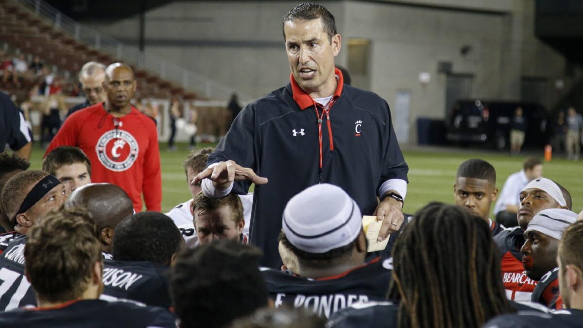 Cincinnati coach Luke Fickell talks to his team after its spring football game on April 14.