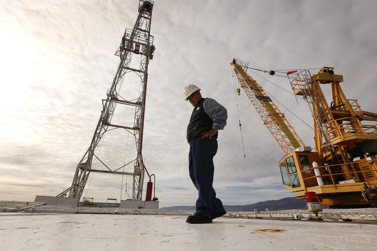 Dave Bautista, operations supervisor for Beacon West, walks the helipad deck high above the ocean on oil Platform Holly off the coast of Santa Barbara.