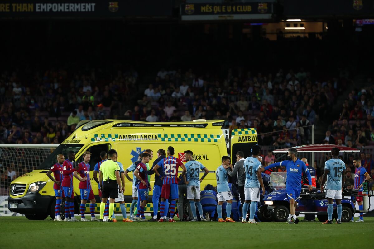 Barcelona's Ronald Araujo is carried by an ambulance after an injury during the Spanish La Liga soccer match between FC Barcelona and Celta Vigo at the Camp Nou stadium in Barcelona, Spain, Tuesday, May 10, 2022. (AP Photo/Joan Monfort)