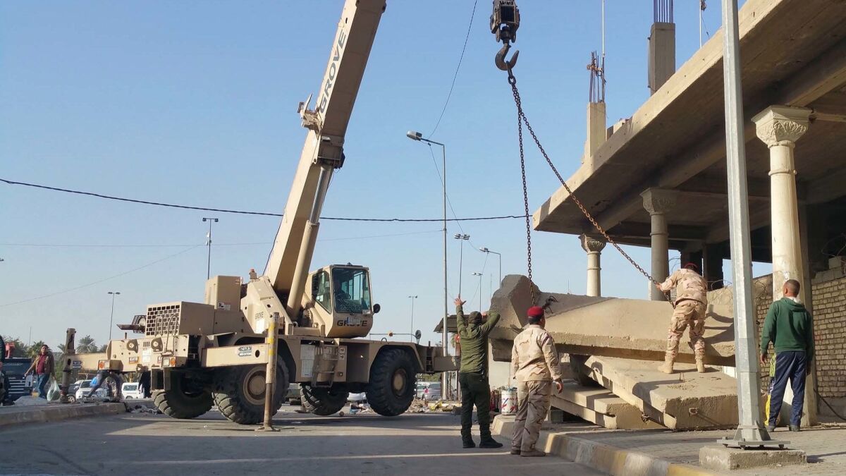 Teams of Iraqi soldiers have been removing the concrete barriers known as t-walls from around the city.