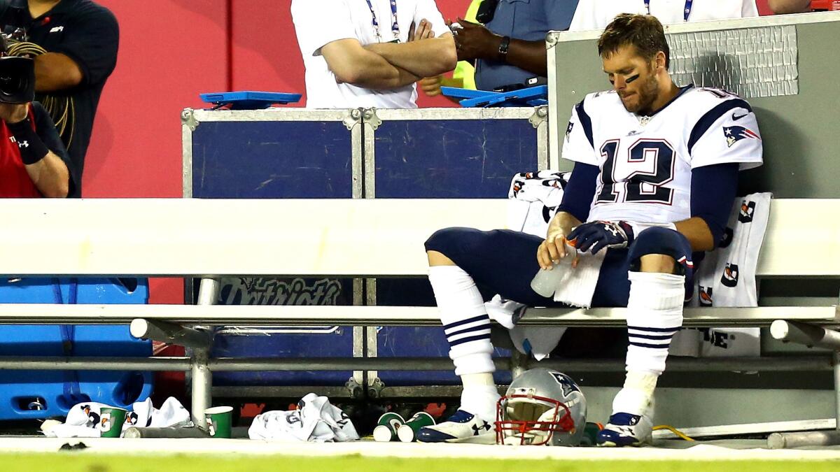 New England Patriots quarterback Tom Brady sits on the bench during a loss to the Kansas City Chiefs on Sept. 29, 2014.