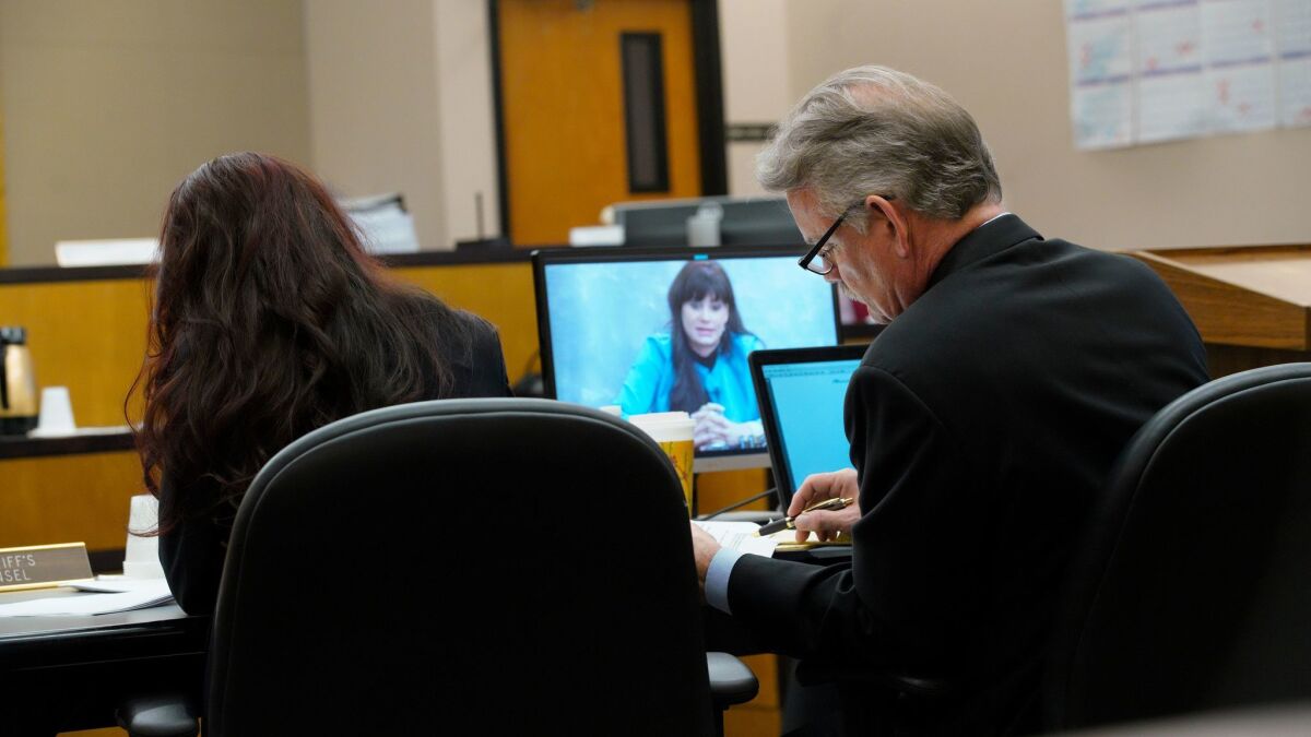 C. Keith Greer, attorney for plaintiff Mary Zahau-Loehner (left), reviews over his notes as the video playback of Dina Shacknai's deposition taken on January 11, 2018 is played in court for the jury.