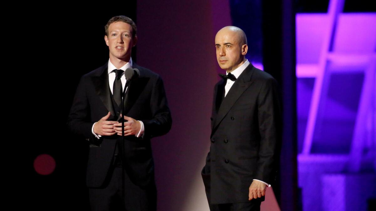 Breakthrough Prize co-founders Mark Zuckerberg, left, and Yuri Milner speak at NASA Ames Research Center in 2016 in Mountain View, Calif.