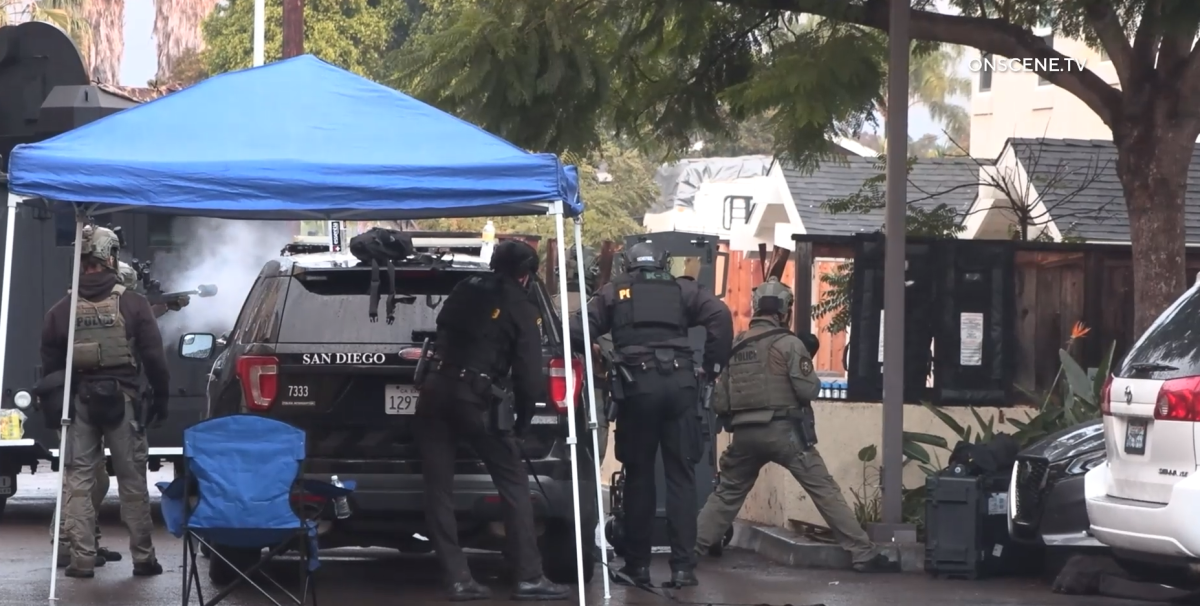 SWAT officers outside a home