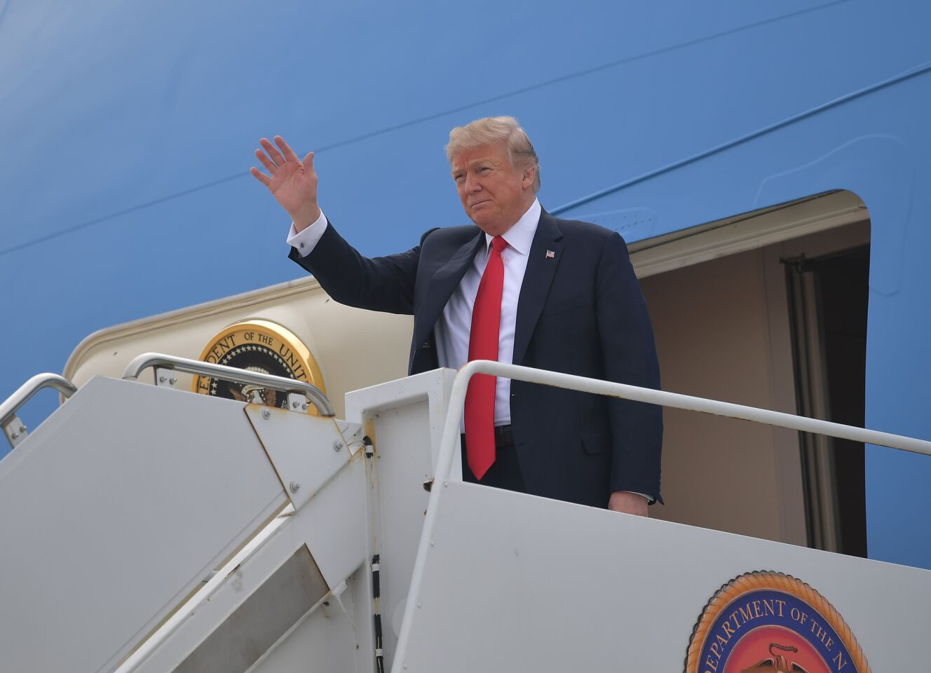 President Trump waves from Air Force One upon his arrival at Marine Corps Air Station Miramar near San Diego on March 13.