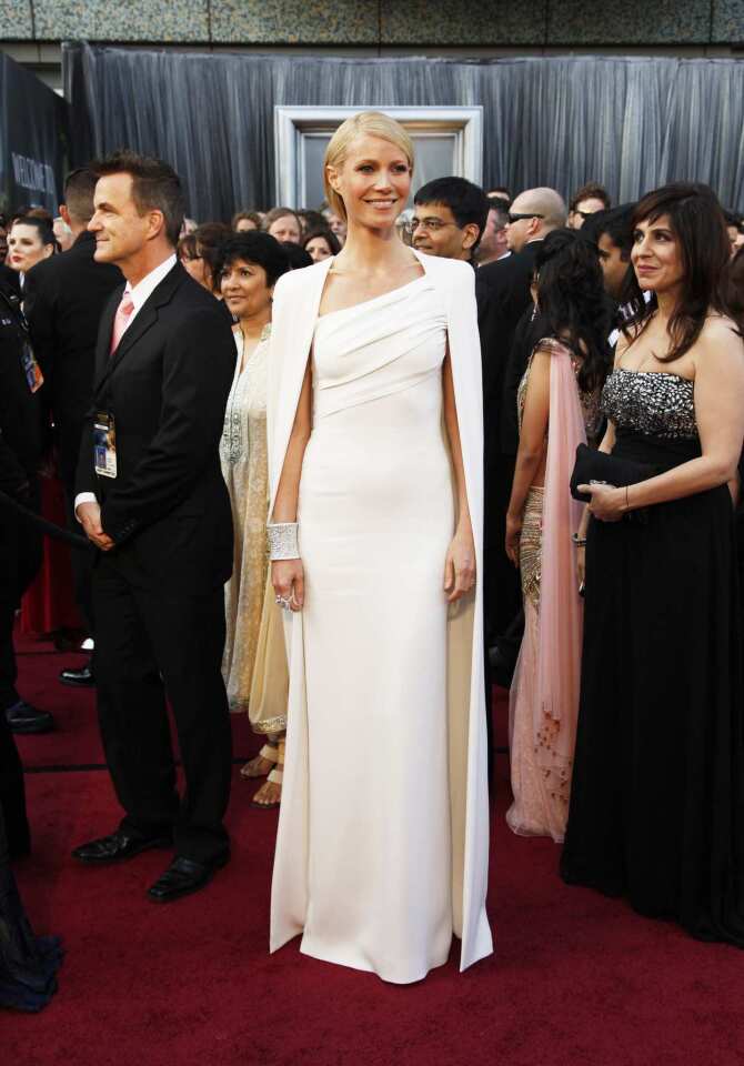 Gwyneth Paltrow's Tom Ford cream column gown and matching cape were stunning in their regal simplicity.