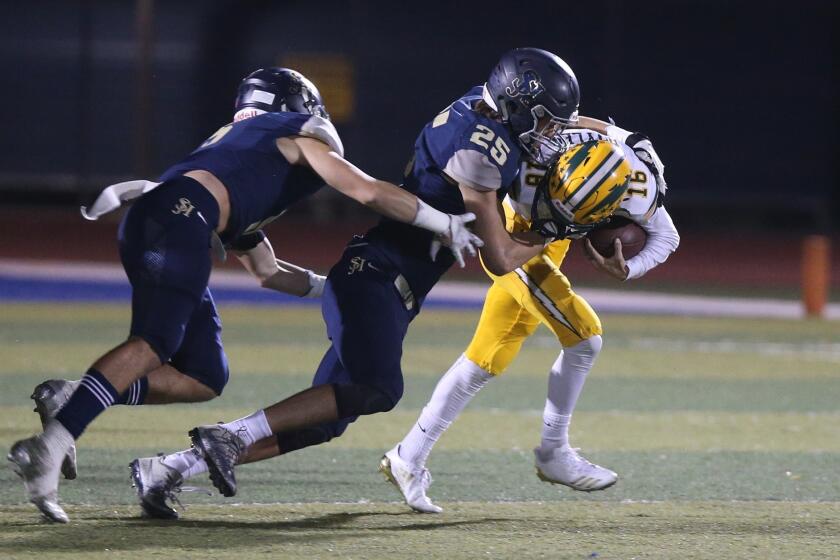 Edison quarterback Braeden Boyles is brought down by San Juan Hills lineman Tyler Wegis in the first round of the CIF Southern Section Division 2 football playoffs on Friday.