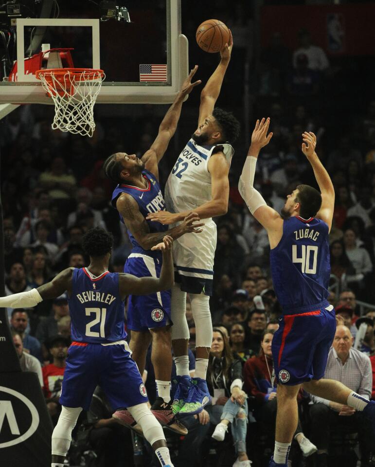 Timberwolves center Karl-Anthony Towns (32) goes over Clippers forward Kawhi Leonard (2) for a basket during the second half of a game Feb. 1 at Staples Center.