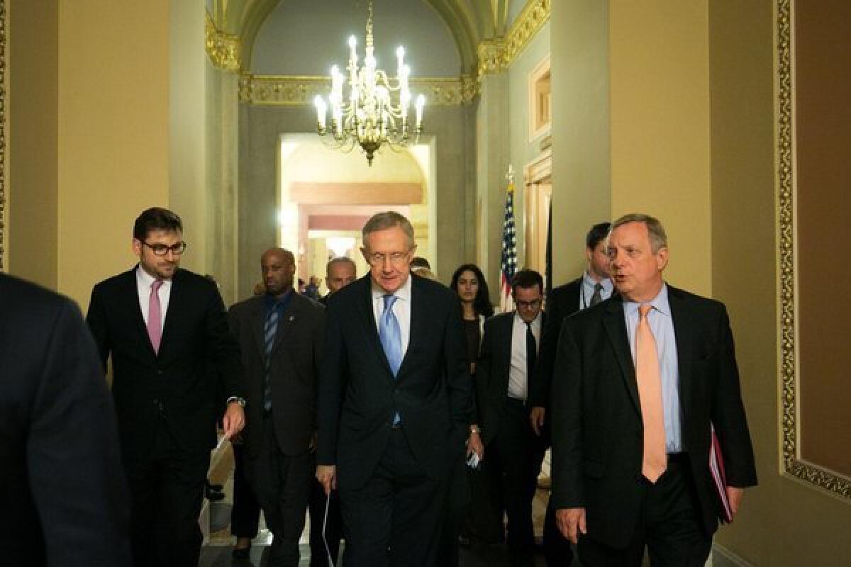 Senate Majority Leader Harry Reid (D-Nev.) walks with Sen. Dick Durbin (D-Ill.) after a joint caucus meeting on Capitol Hill.