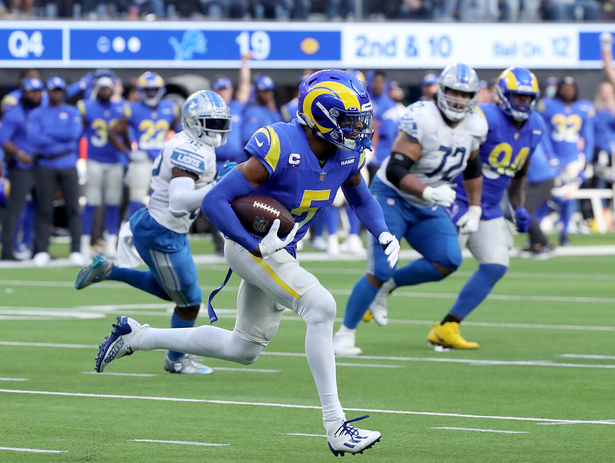 Rams cornerback Jalen Ramsey runs with the ball after intercepting a pass from Lions quarterback Jared Goff.