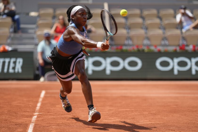 Coco Gauff of the U.S. plays a shot against Poland's Iga Swiatek during their quarterfinal match of the French Open tennis tournament at the Roland Garros stadium in Paris, Wednesday, June 7, 2023. (AP Photo/Thibault Camus)