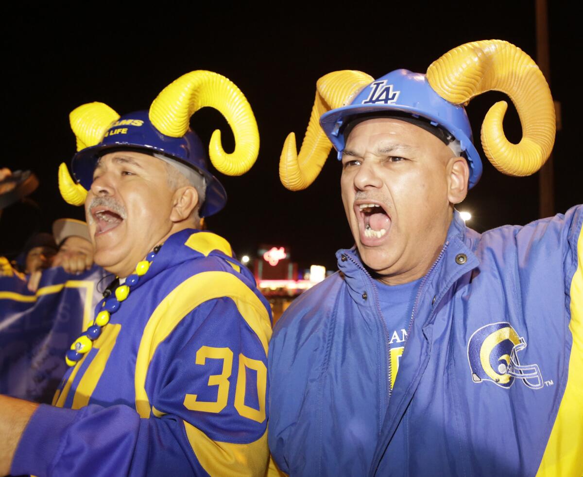 Football fans cheer for the return of the Rams to Los Angeles on the site of the old Hollywood Park horse-racing track in Inglewood on Tuesday, Jan. 12, 2016. Should switching venues be an opportunity to switch up the uniforms? Some fans say: "Don't mess with the horns."