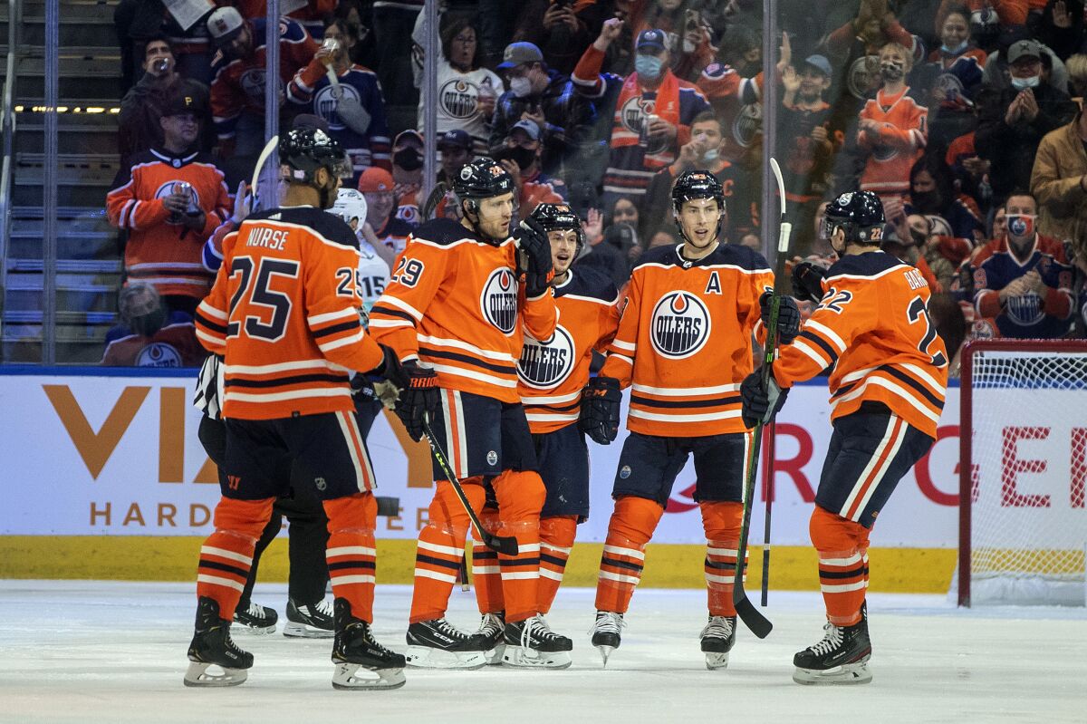 The Edmonton Oilers celebrate a goal during the first period of an NHL hockey game against the Seattle Kraken, in Edmonton, Alberta, Monday, Nov. 1, 2021. (Jason Franson/The Canadian Press via AP)