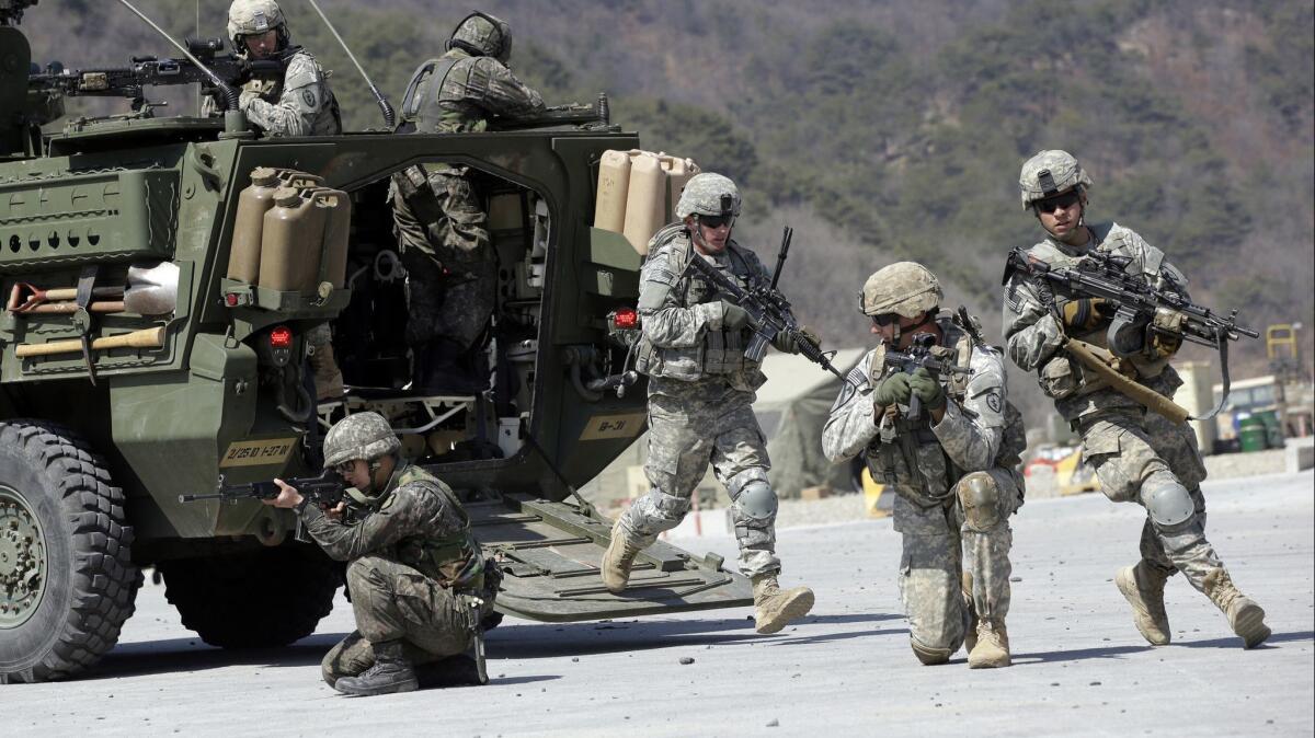 U.S. and South Korean soldiers take positions during joint military exercises north of Seoul in 2015.