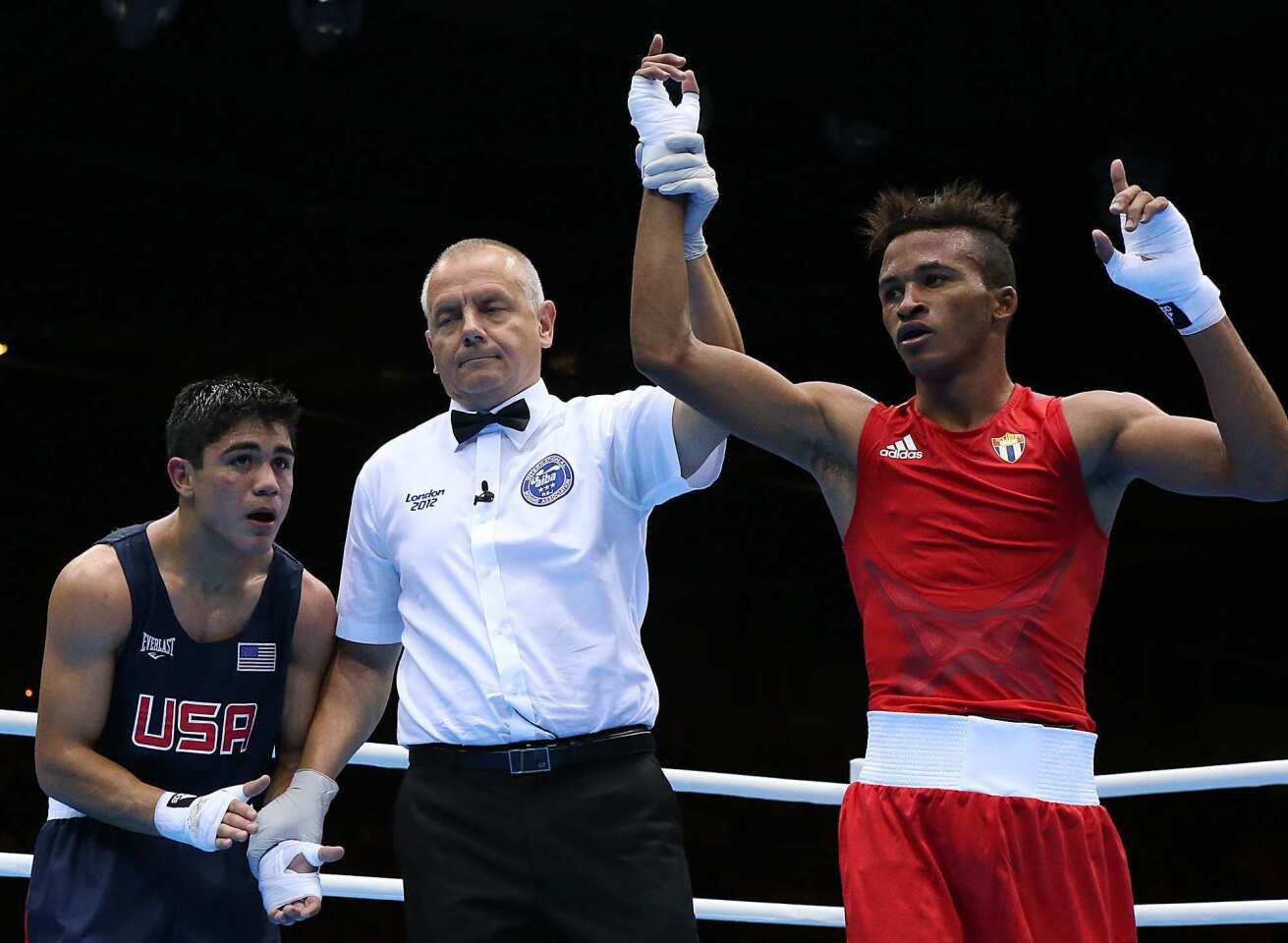 U.S. boxer Joseph Diaz Jr. claps for his opponent after losing a 21-15 decision to world champion Lazaro Alvarez of Cuba in a bantamweight fight at the ExCel South Arena.