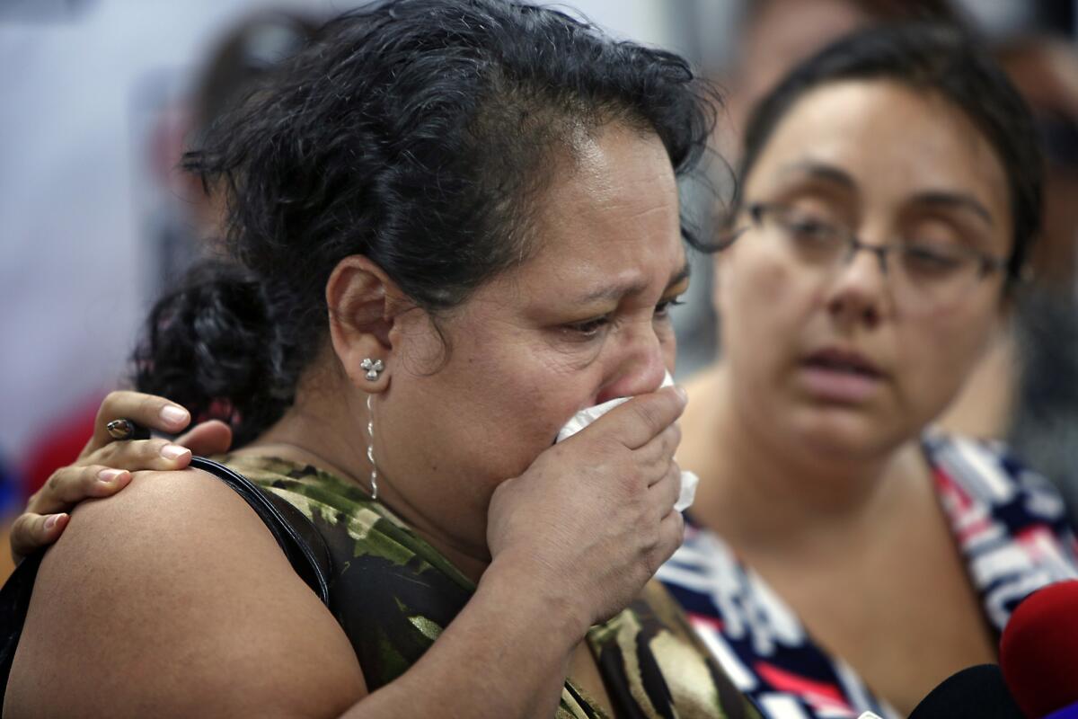 Gloria Torres becomes emotional during a news conference Thursday, where she and other former employees of Vynl Technology Inc. said they had been pressured to resign amid an audit by U.S. Immigration and Customs Enforcement.