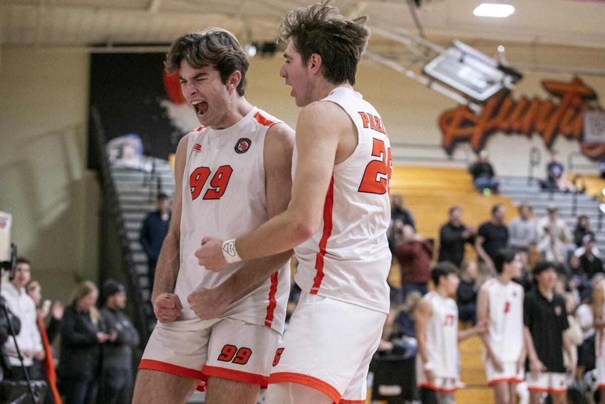 Huntington Beach's Ben Bray, left, and Jake Pazanti celebrate a point against Beckman on Thursday.