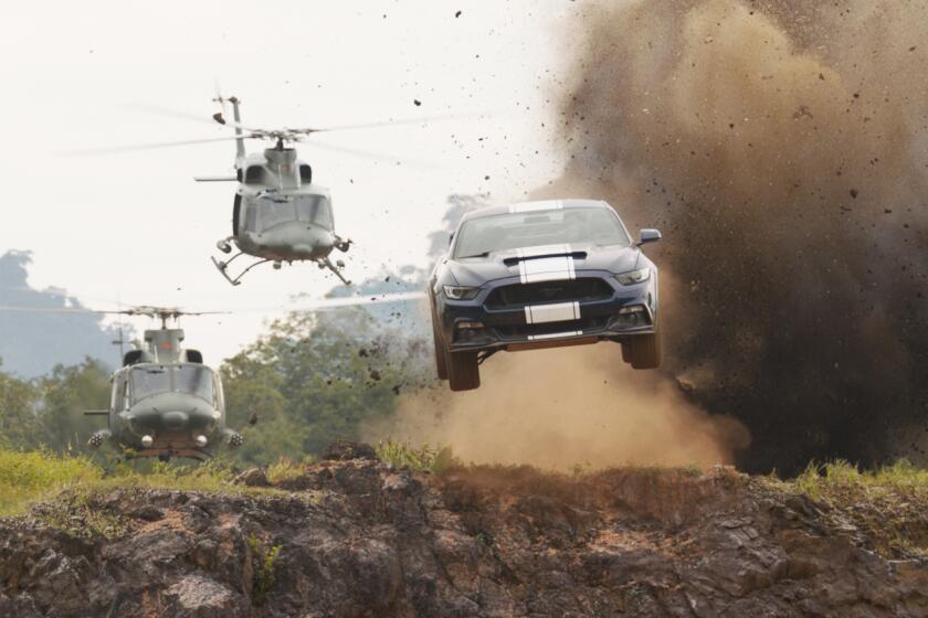 Two helicopters pursue a car in a scene from “F9” a.k.a. “Fast & Furious Nine.”