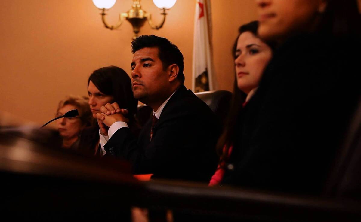 State Sen. Ricardo Lara (D-Bell Gardens), center, attends a Senate Rules Committee meeting at the Capitol in Sacramento. Lara's parents immigrated to the United States from Mexico, and their struggle has influenced how he legislates.