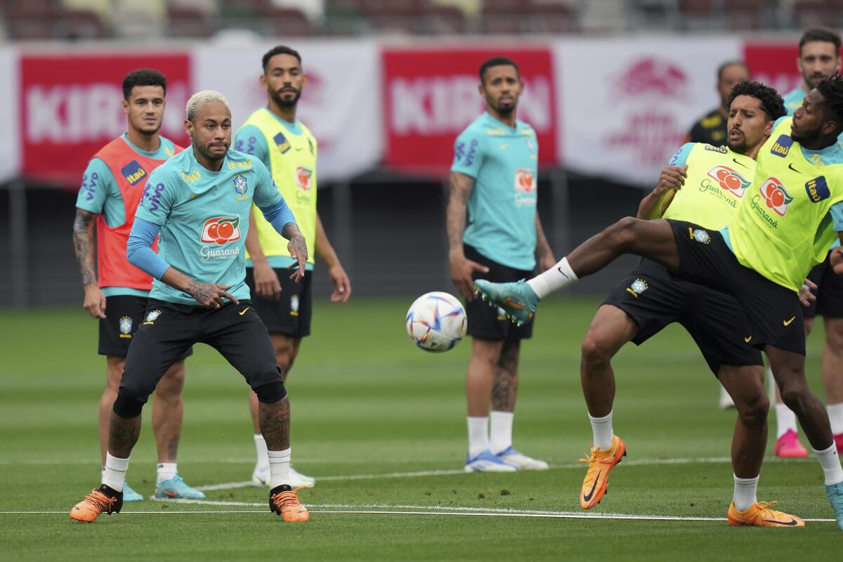 Brazil's Neymar, second left, warms up with teammates during an official training session at the National Stadium in Tokyo Sunday, June 5, 2022. Brazil national soccer team will play a friendly soccer match against Japan on June 6. (AP Photo/Eugene Hoshiko)