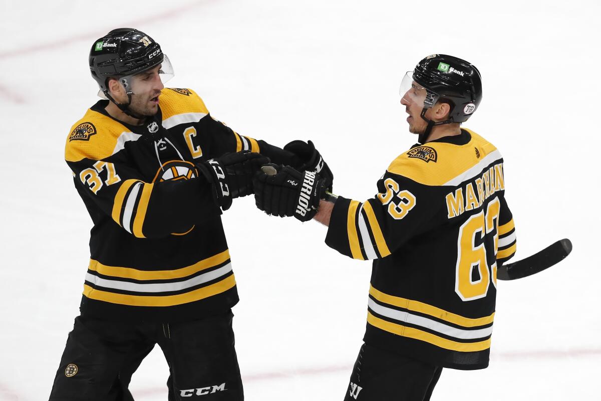 Brad Marchand and Patrice Bergeron share a moment at Charlie