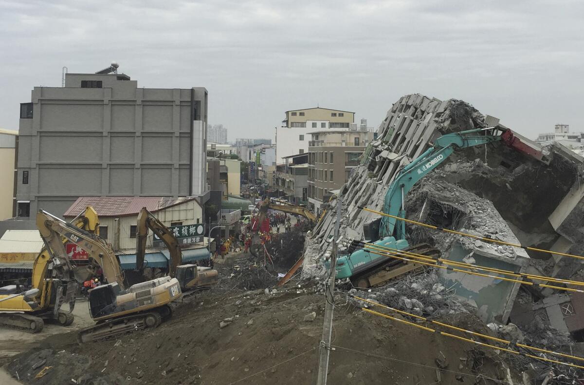Rescue workers using excavators continue to search the rubble of a collapsed building complex in Tainan, Taiwan.