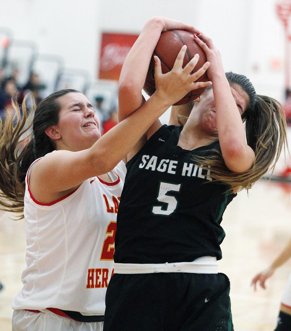 Sage Hill's Zoe Mazakas (5) battles Whittier Christian's Haley Gainer for the ball in a nonleague game on Thursday in La Habra.