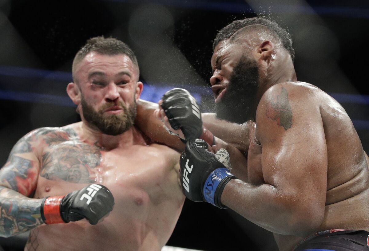 Daniel Omielanczuk, left, and Curtis Blaydes trade punches during their heavyweight fight at UFC 213.