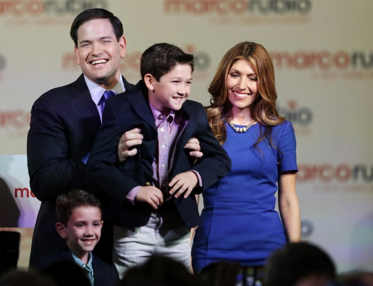 Sen. Marco Rubio (R-Fla.), with wife Jeanette, holds up his son Anthony on Monday after announcing his presidential candidacy.