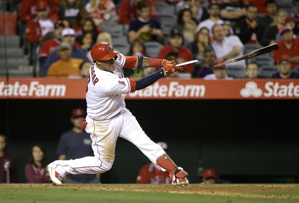 Angels third baseman Yunel Escobar breaks his bat as he hits a walk-off single to beat the Indians on June 11.