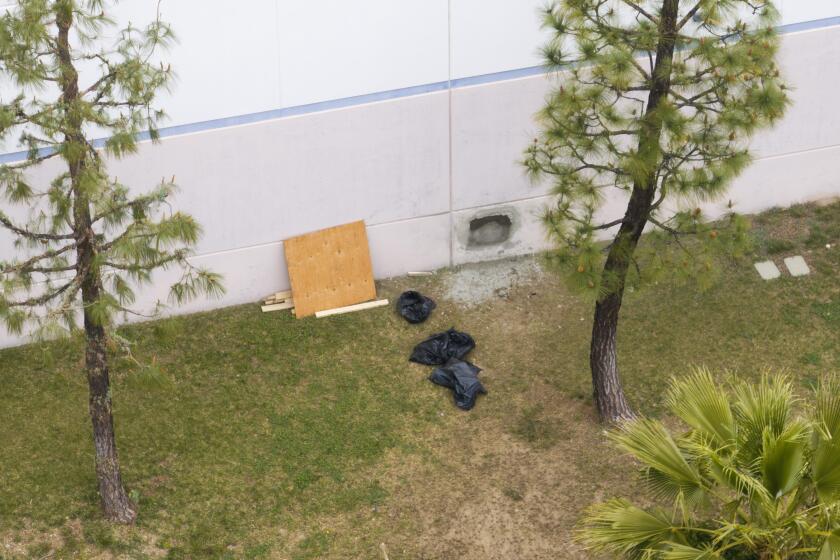 LOS ANGELES, CA- APRIL 04: Damage to a wall seems to be under repair at Gardaworld in Sylmar on Thursday, April 4, 2024. (NEWS REPORTS SAID THEY ENTERED THROUGH THE ROOF) Thieves made off with as much as $30 million in an Easter Sunday burglary from the facility. (Myung J. Chun / Los Angeles Times)