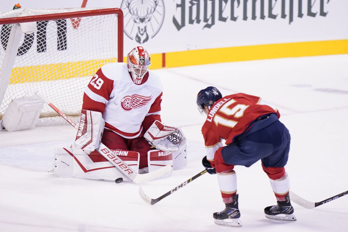 Florida Panthers center Anton Lundell (15) attempts a shot at Detroit Red Wings goaltender Thomas Greiss (29) during the first period of an NHL hockey game, Saturday, March 5, 2022, in Sunrise, Fla. (AP Photo/Wilfredo Lee)
