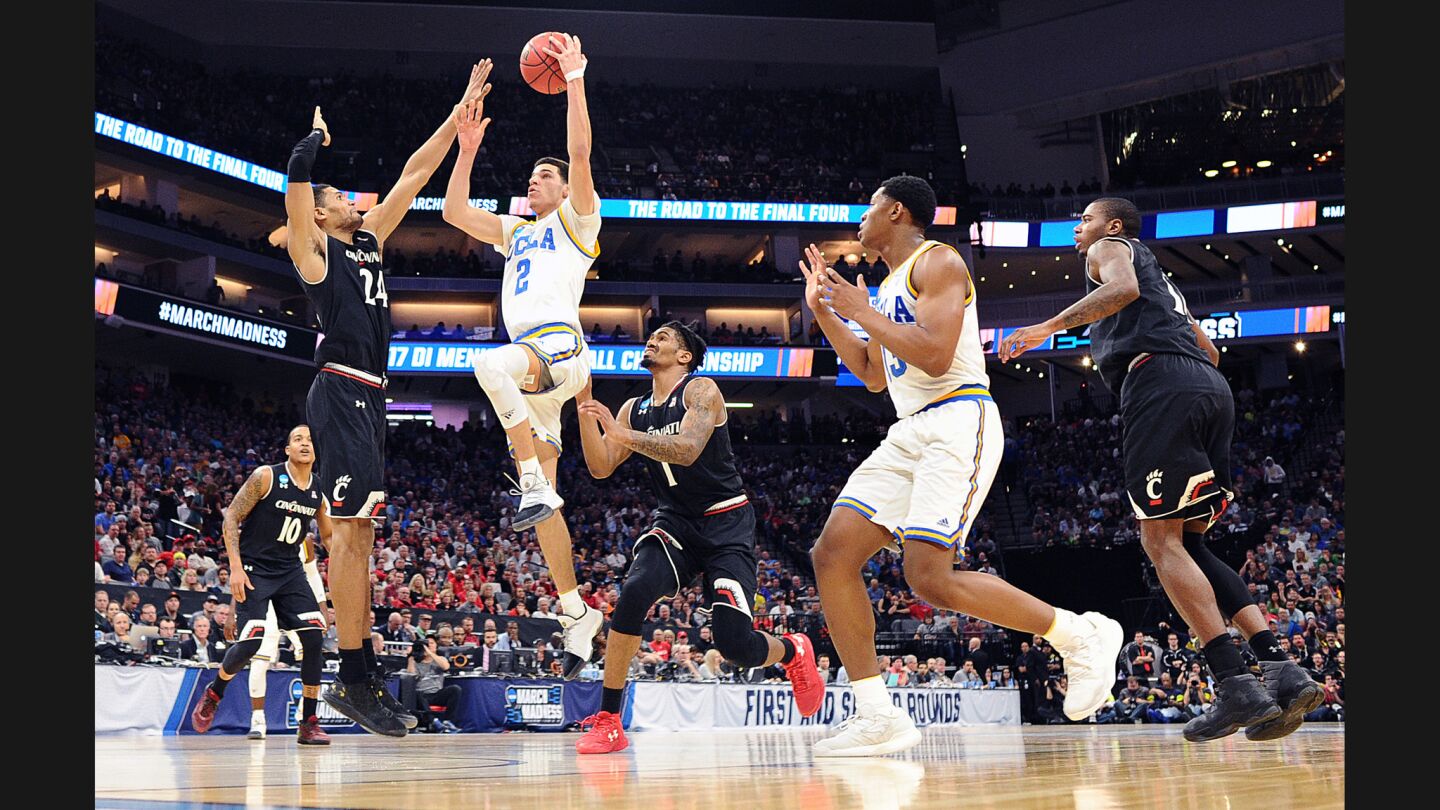UCLA guard Lonzo Ball drives through the Cincinnati defense to score a basket during the second half.