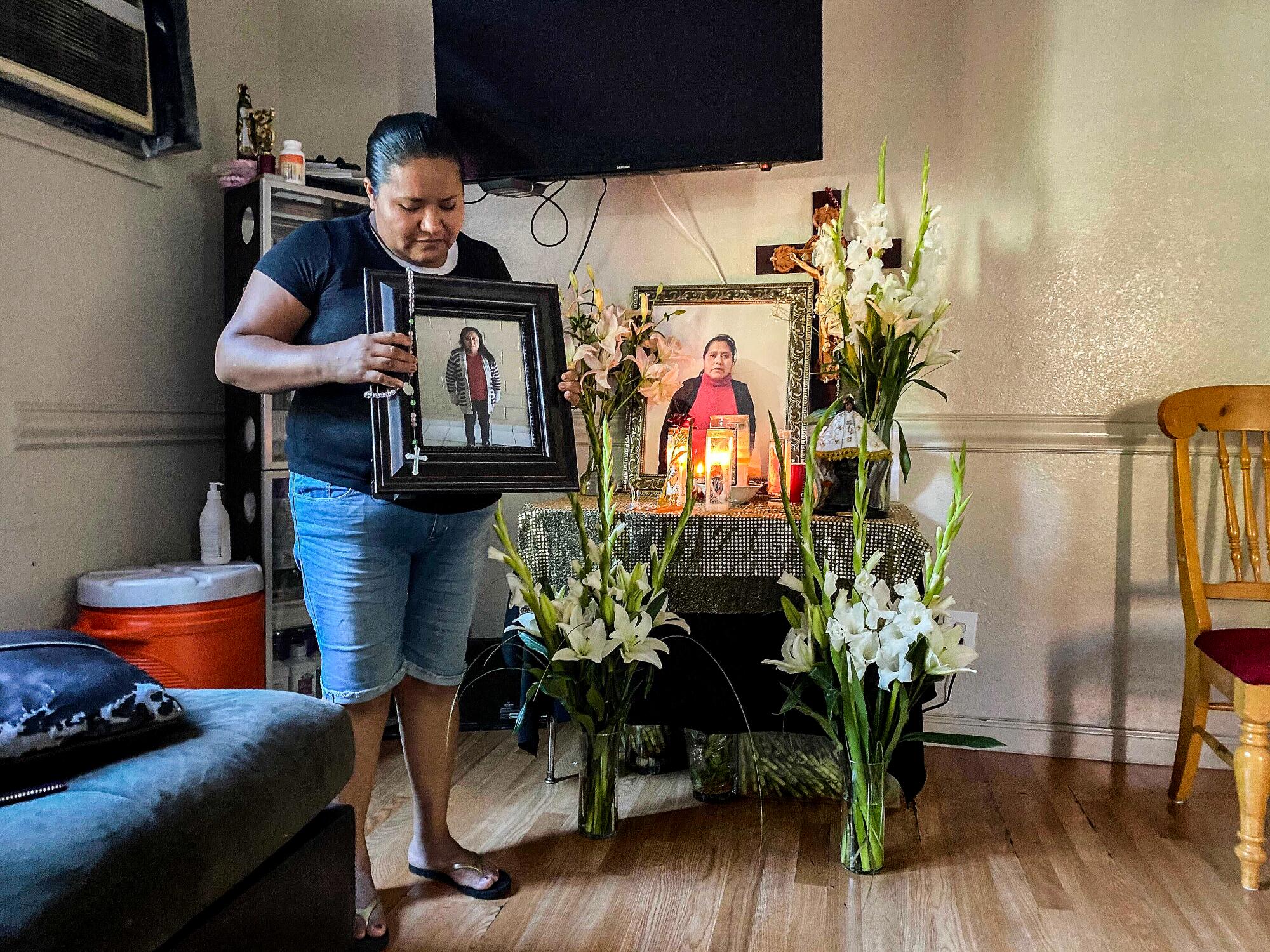 Maria Eugenia Chavez Segovia's sister Gabriela clutches a picture of her at her home in northern California.