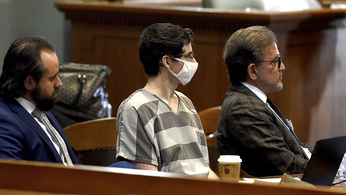 Convicted murderer Joseph Elledge, center, listens with his attorneys Scott Rosenblum, right, and Matei Stroescu, Friday Jan. 7, 2022, in Columbia, Mo., during the sentencing phase his trial. Elledge was convicted of second-degree murder in the 2019 killing of his wife, Mengqi Ji. (Don Shrubshell/Columbia Daily Tribune via AP)