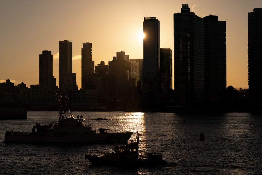 NYPD and Coast Guard boats patrol the East River outside the United Nations headquarters, Wednesday, Sept. 21, 2022, in New York. (AP Photo/Julia Nikhinson)
