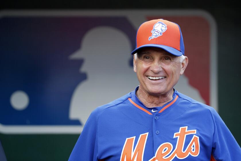 New York Mets Manager Terry Collins smiles as he steps out of the dugout before a game against Washington on Sept. 8.
