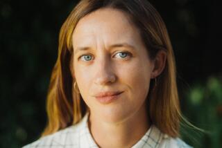 A filmmaker in a button-down top poses for the camera.