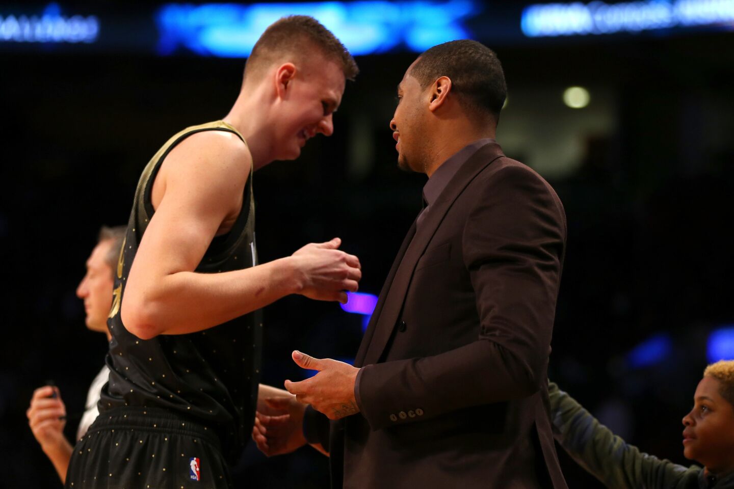 Forward Kristaps Porzingis of the World team is congratulated by Knicks teammate Carmelo Anthony during the first half of the Rising Stars Challenge.