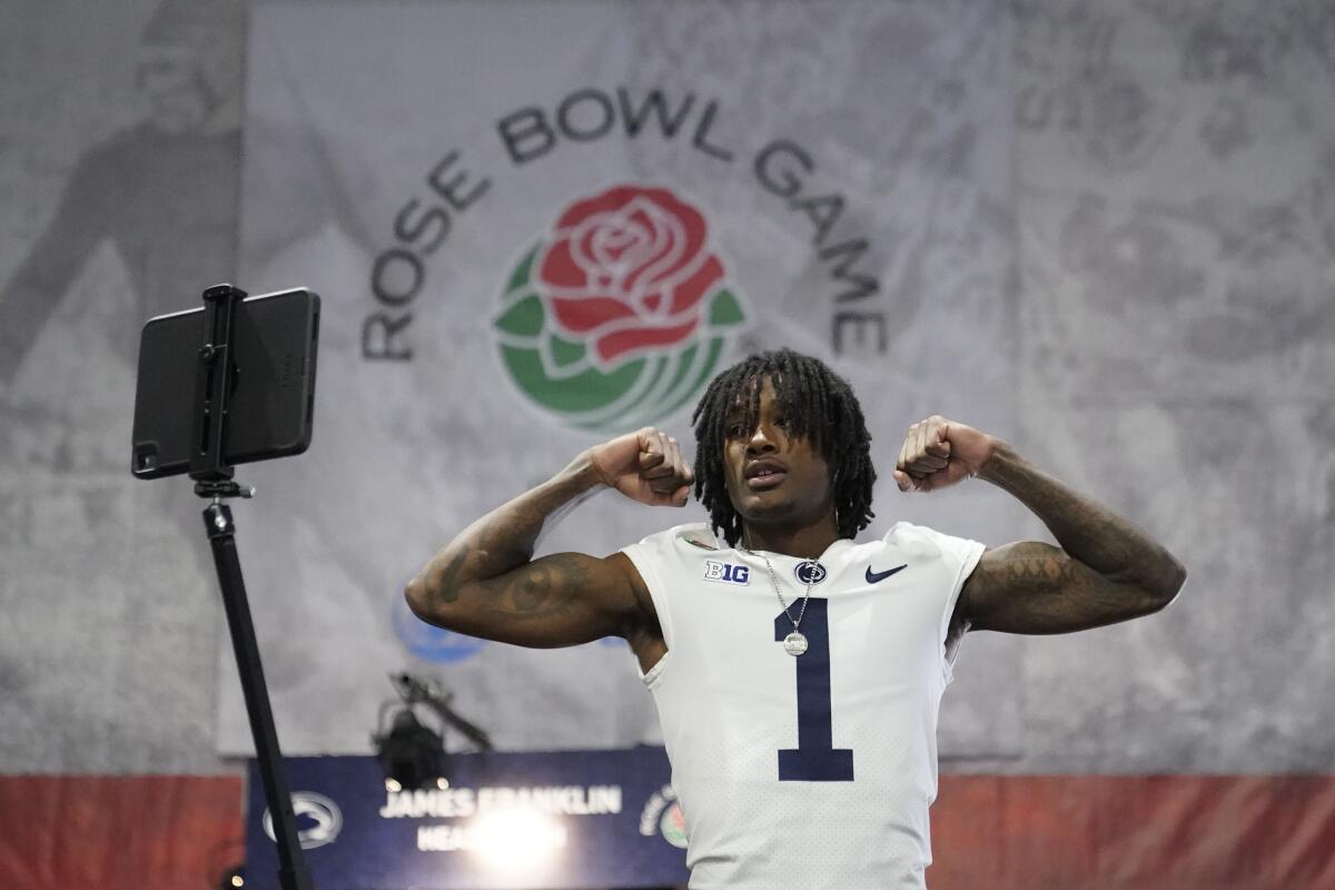 Penn State wide receiver KeAndre Lambert-Smith flexes for a video during Rose Bowl media day on Saturday.